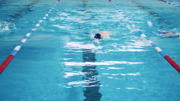 Slow Motion of a Man Swimming Breaststroke in a Front View