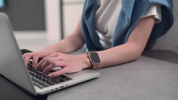 Young Woman Working From Home Remotely Typing on Laptop Keyboard.