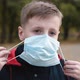 Child Boy Putting on Medical Mask for Coronavirus Prevention. - VideoHive Item for Sale