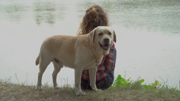 Young Woman and Labrador Near the River