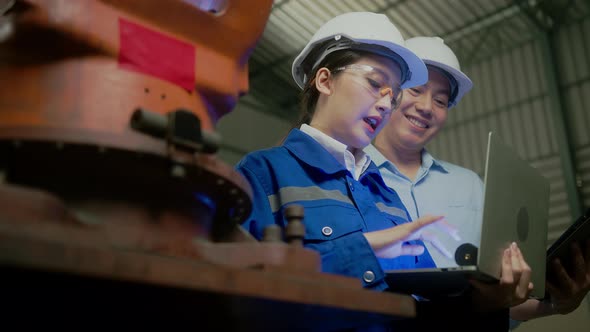 engineer specialist asian female and  technician maintenance inspect relay robot arm