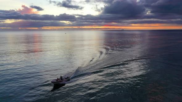 Fishermen driving boat during sunset, Flic en Flac, Mauritius