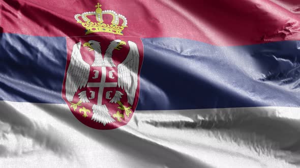 Serbia textile flag waving on the wind. Slow motion. 20 seconds loop.