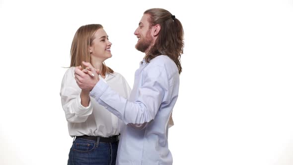 Beautiful Brunette Woman and Handsome Man Dancing on First Date Isolated on White Background.