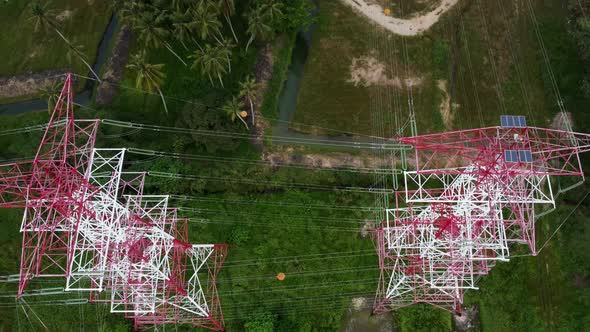 Red and white metal electric transmission tower. 