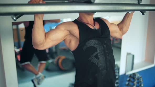 Athlete Doing Pullup on Horizontal Bar in the Gym