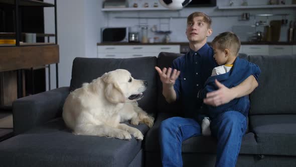 Positive Parent Tossing the Ball for Little Son