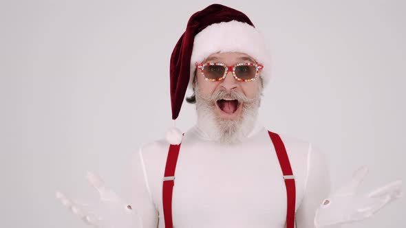 Smiling Gray-haired Santa Claus Man in Christmas Hat and Suspenders Isolated on Vwhite Background