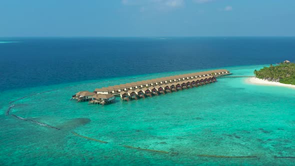 Aerial view of luxury water villas resort on Maldives island