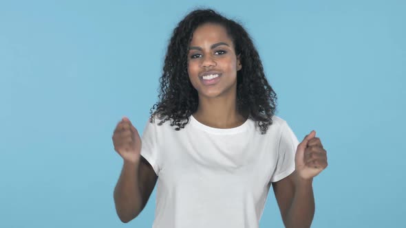 Pleased Smiling African Girl Dancing Isolated on Blue Background