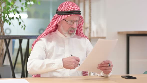 Senior Old Arab Businessman Having Failure on Documents