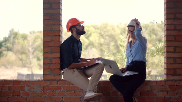 Civil Engineer Architect On Development. Two Engineer Builder In Helmet Inspecting Building.