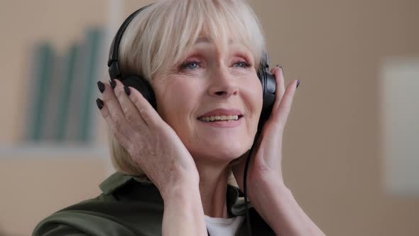 Portrait Happy Relaxed Blonde 60s Grandmother Dancing Old Caucasian Woman in Headphones Carefree