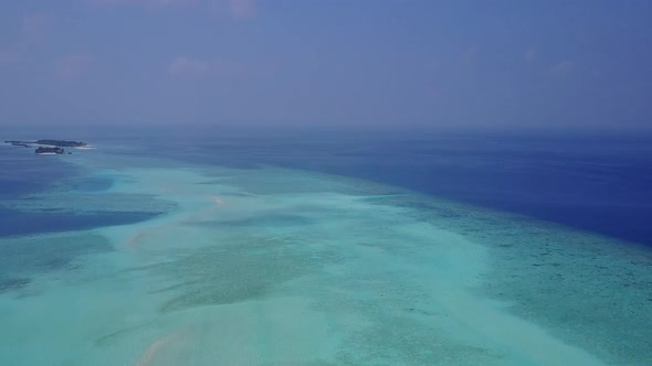 Aerial travel of bay beach by blue lagoon with sand background