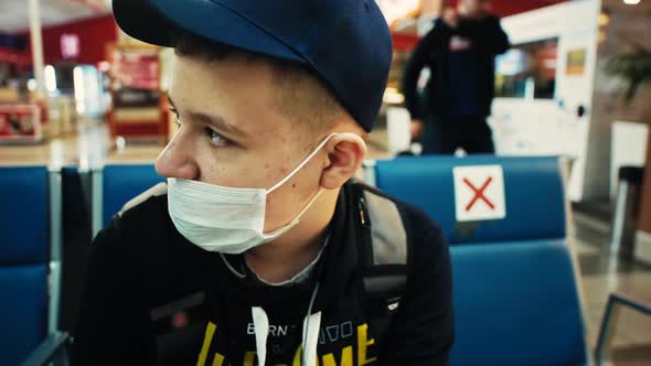 Young Man in Airport Terminal Lounge