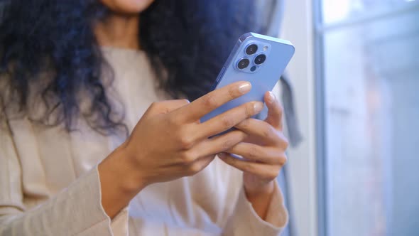 Black woman use modern smartphone with triple camera