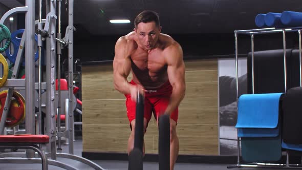 Adult Pumped Up Man Doing Rope Exercise