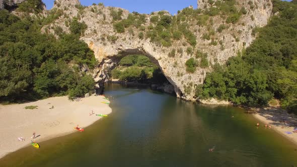 Aerial travel drone view of the Pont d Arc natural arch and river, Southern France.