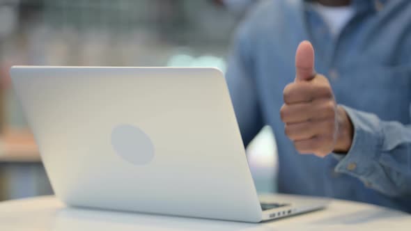 Man Working on Laptop and Showing Thumbs Up Sign Close Up