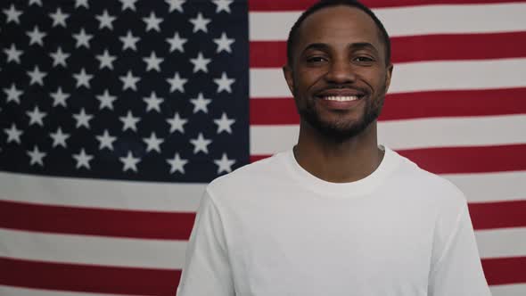Video of cheerful black man on American flag background. Shot with RED helium camera in 8K