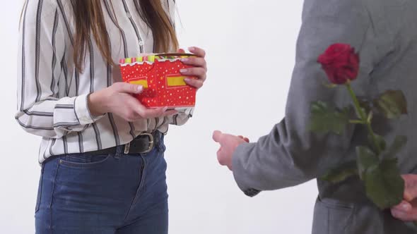 Unrecognized Man and Woman on a Date, Man Give Present and Red Rose for Woman