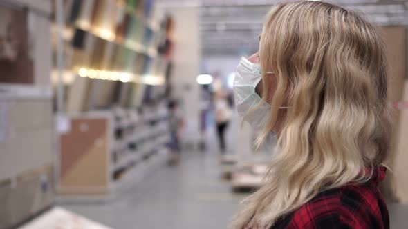 Portrait of Shopper Woman in Medical Mask in a Large Supermarket