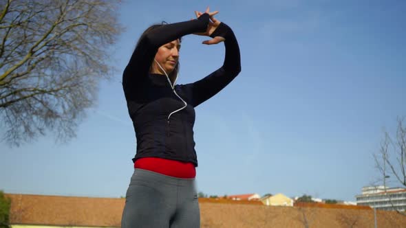 Beautiful Focused Sportswoman Exercising in Park