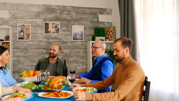 Happy and Cheerful Family Enjoying a Delicious Dinner