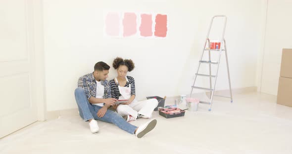 Young Couple Use Tablet To Discuss Colors