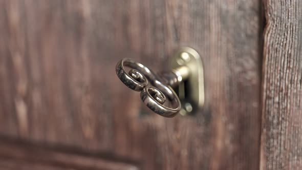 Animation of opening an older golden door lock. Close-up view at a key. 4KHD