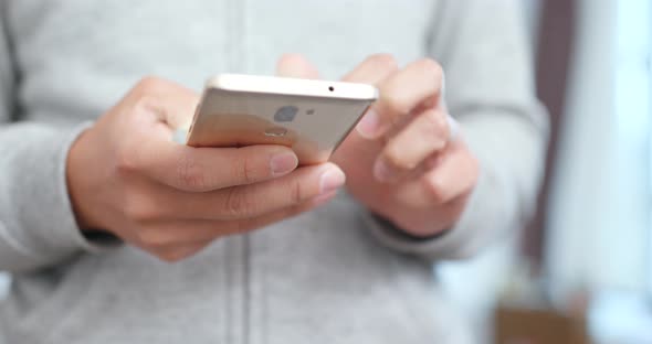 Woman working on smart phone at home