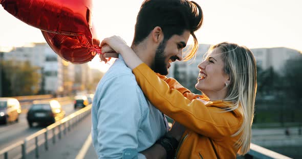 Couple in Love Cuddling While Enjoying Beautiful Urban Sunset Together