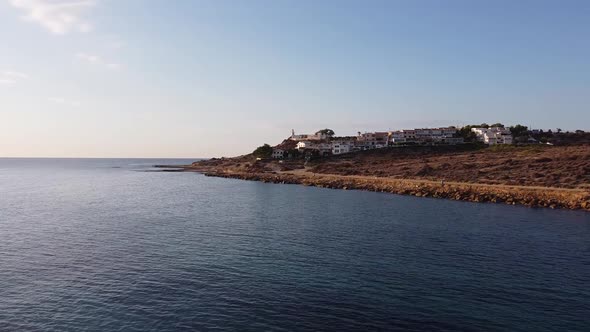 Aerial approach to village and lighthouse close to the Mediterranean sea. Cabo de las Huertas, Alica