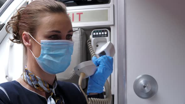 Close Up Stewardess with Mouth Protection Mask Using Public Address