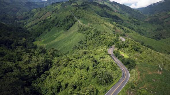 Countryside Road Passing Through The Mountain Landscape 