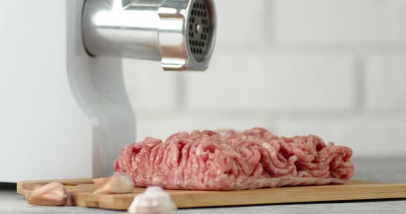 Raw Minced Meat with a Meat Grinder on the Table Rotate