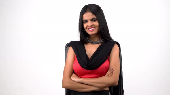 Happy Indian girl standing crossed hands and smiling