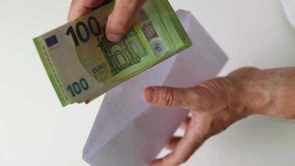 Man Counting Cash Money From Envelope