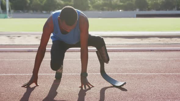 Disabled mixed race man with prosthetic legs stretching