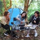 Group of young women cooking while camping in park - VideoHive Item for Sale