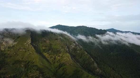 Clouds Envelop the Mountains in the Autumn Landscape