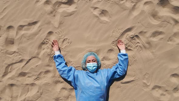 Funny Set: Tired Female Doctor in Medical Gear Lying on Sandy Beach