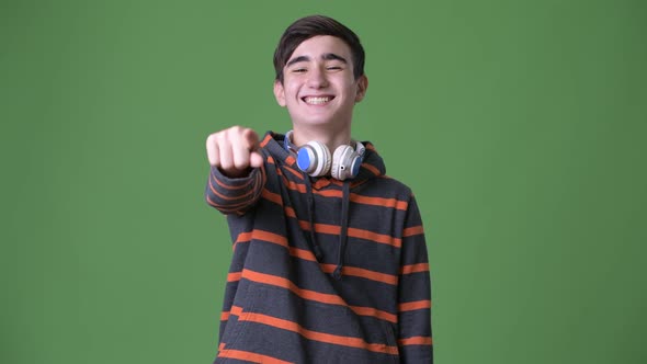 Young Handsome Iranian Teenage Boy Against Green Background