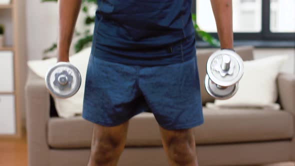 Indian Man Exercising with Dumbbells at Home