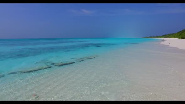 Aerial drone scenery of relaxing seashore beach voyage by blue water and white sandy background of a