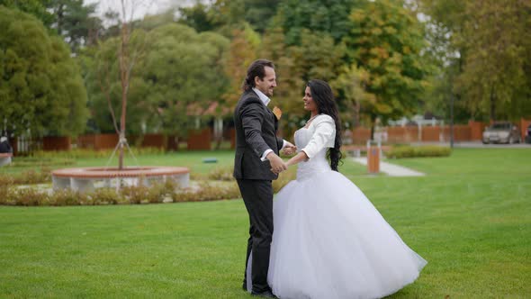 Playful Groom and Bride are Dancing Wedding Dance Outside Romantic Moments in Wedding Day