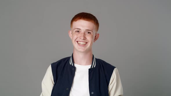 Portrait of cheerful red head caucasian teenage man with toothy smile. Shot with RED helium camera i