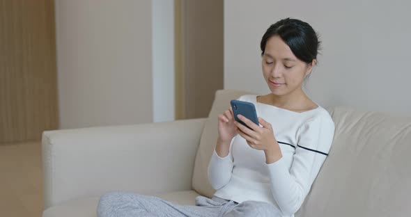 Woman use of mobile phone at home