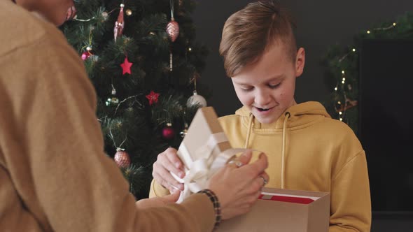 Mother Giving Christmas Present to Son