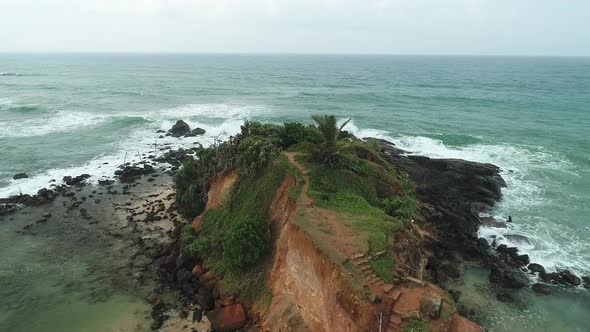 Flyover Coastal Rock Mound Towards The Ocean